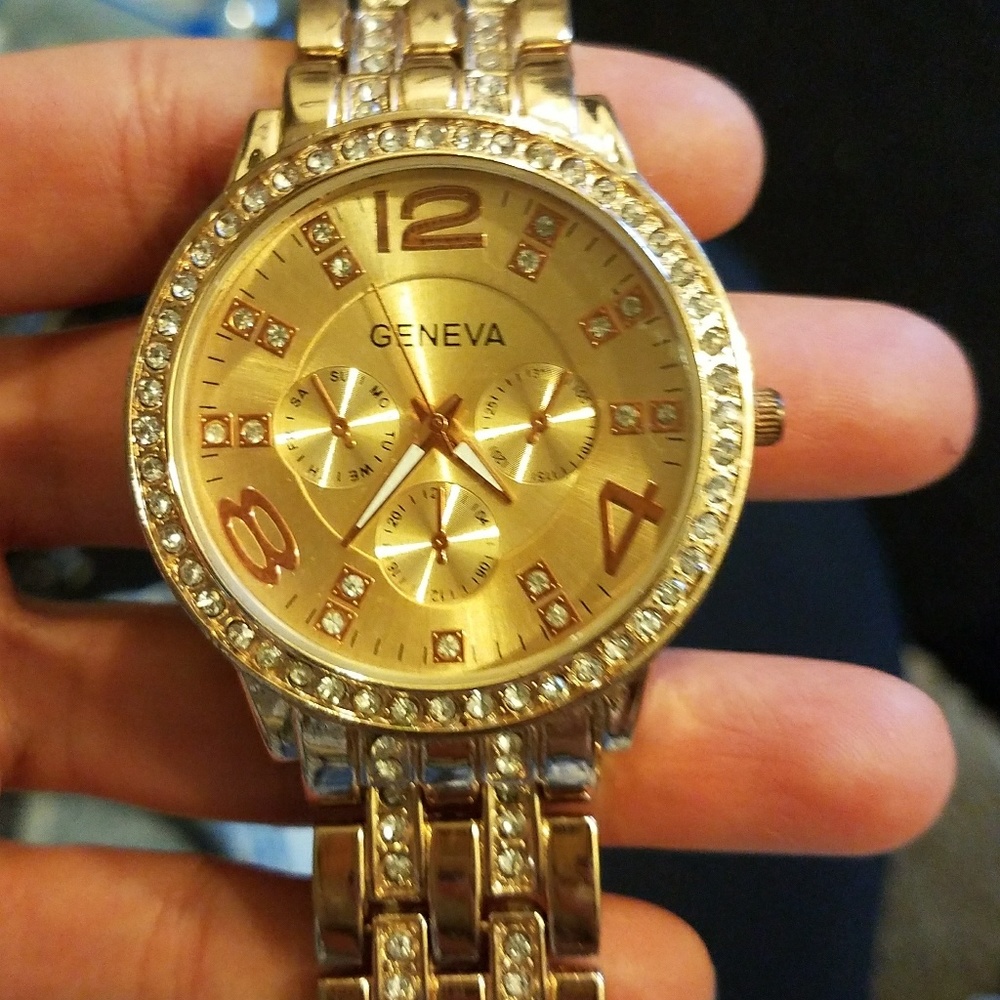 Round gold watch with link bracelet